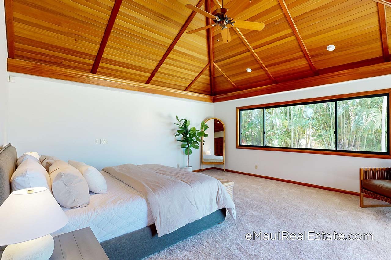 Primary bedroom with high vaulted ceilings